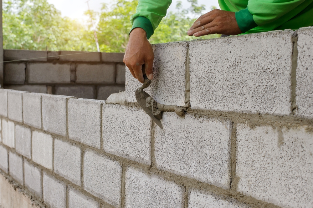Bricklayer laying blocks